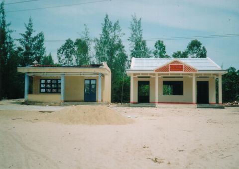 Left side: damaged house after wind storms. Right side: strengthened house undamaged in Tam Ky.