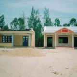 Left side: damaged house after wind storms. Right side: strengthened house undamaged in Tam Ky.